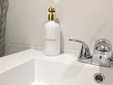 Bathroom sink and toiletries — Stylish Modern 1BR with EV Charger