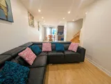 Living room with sofa and television — Spacious 2BR Holiday Home Near YUL