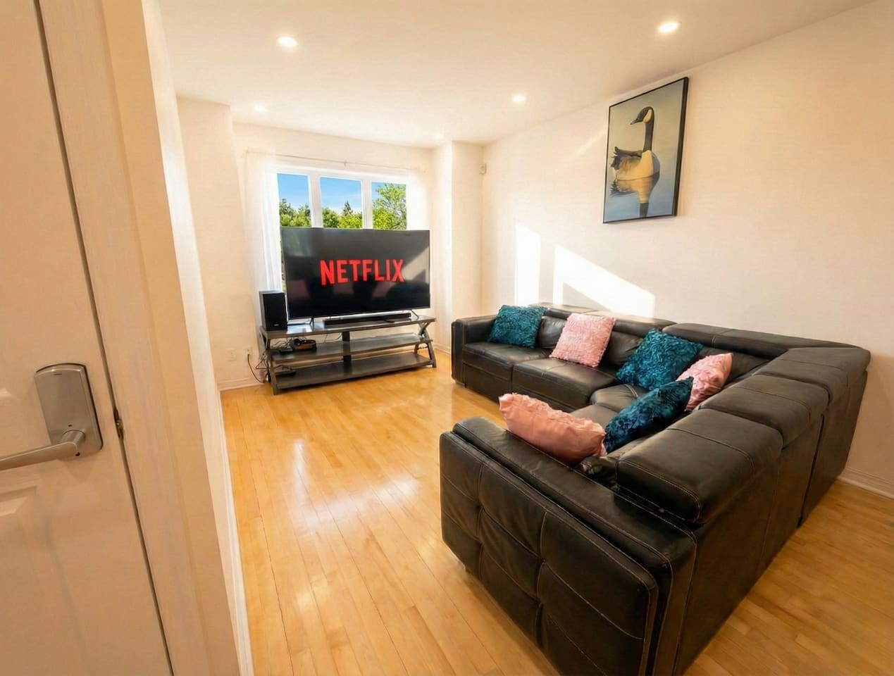 Living room with sofa and television — Spacious 2BR Holiday Home Near YUL